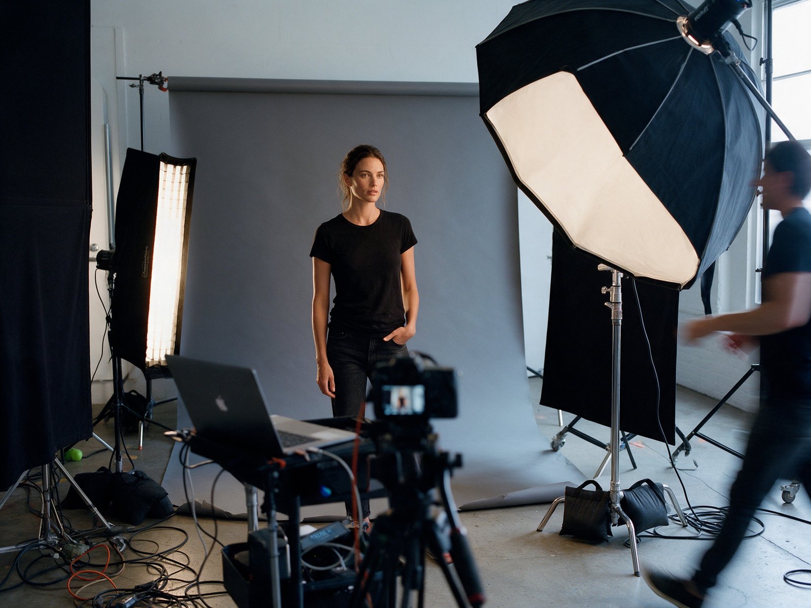 Candid behind-the-scenes photo of the model on a studio shoot