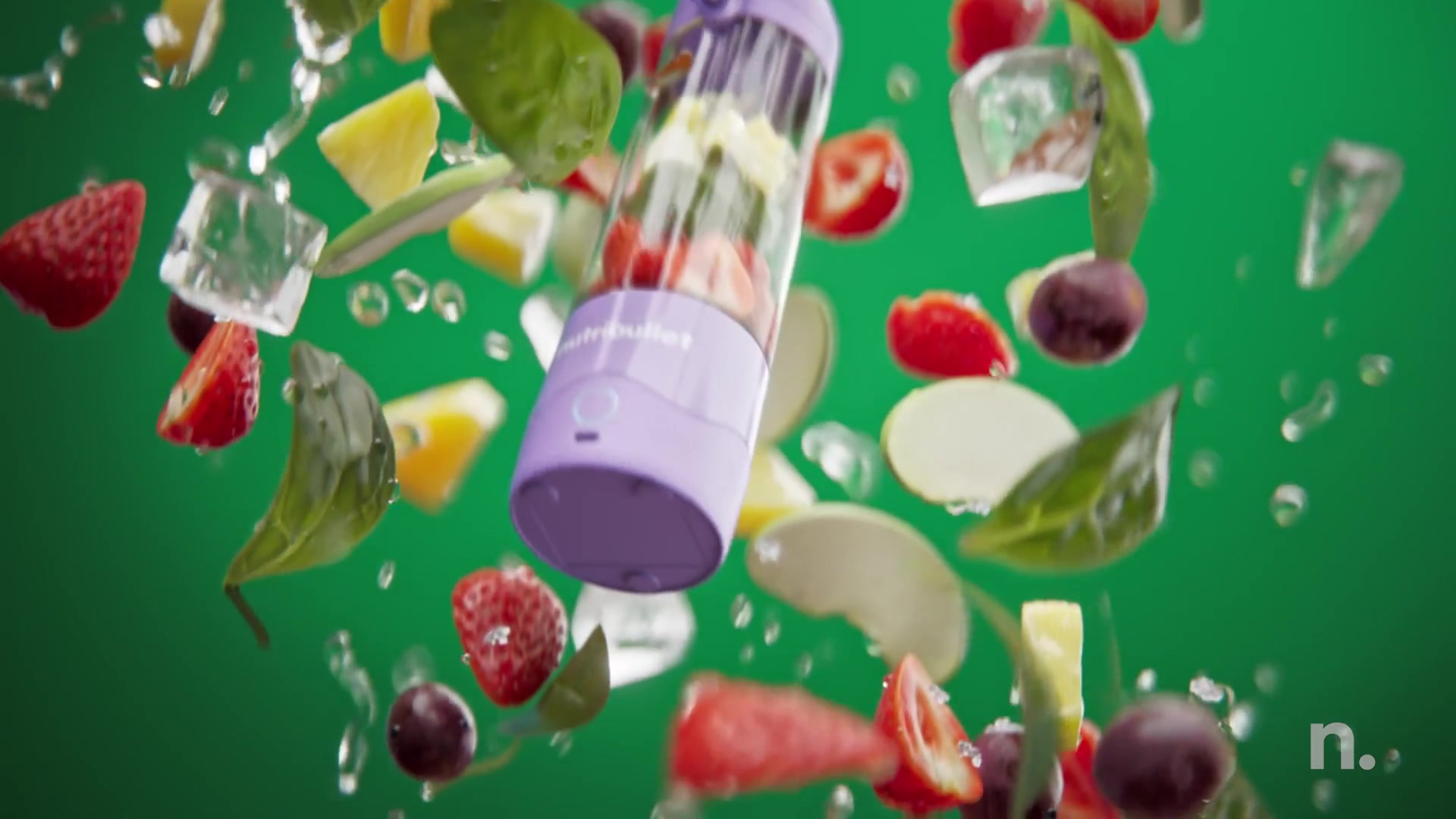 Lilac Nutribullet Portable among flying fruit and leaves on green