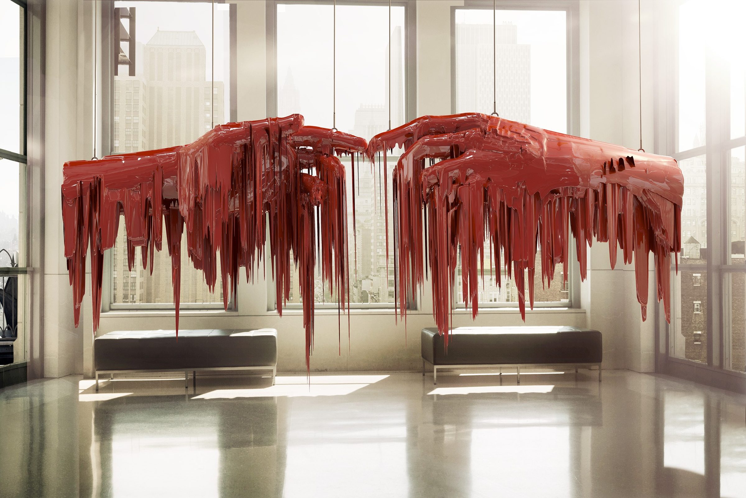 Rockefella Hands: two red dripping sculpted hands hanging in a sunlit New York lobby