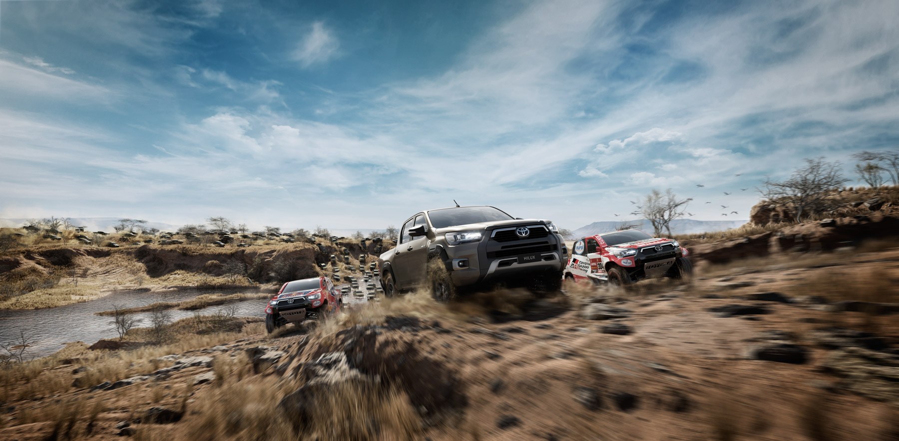 Toyota Hilux trucks and Toyota Gazoo Racing rally trucks racing through a CGI African river canyon